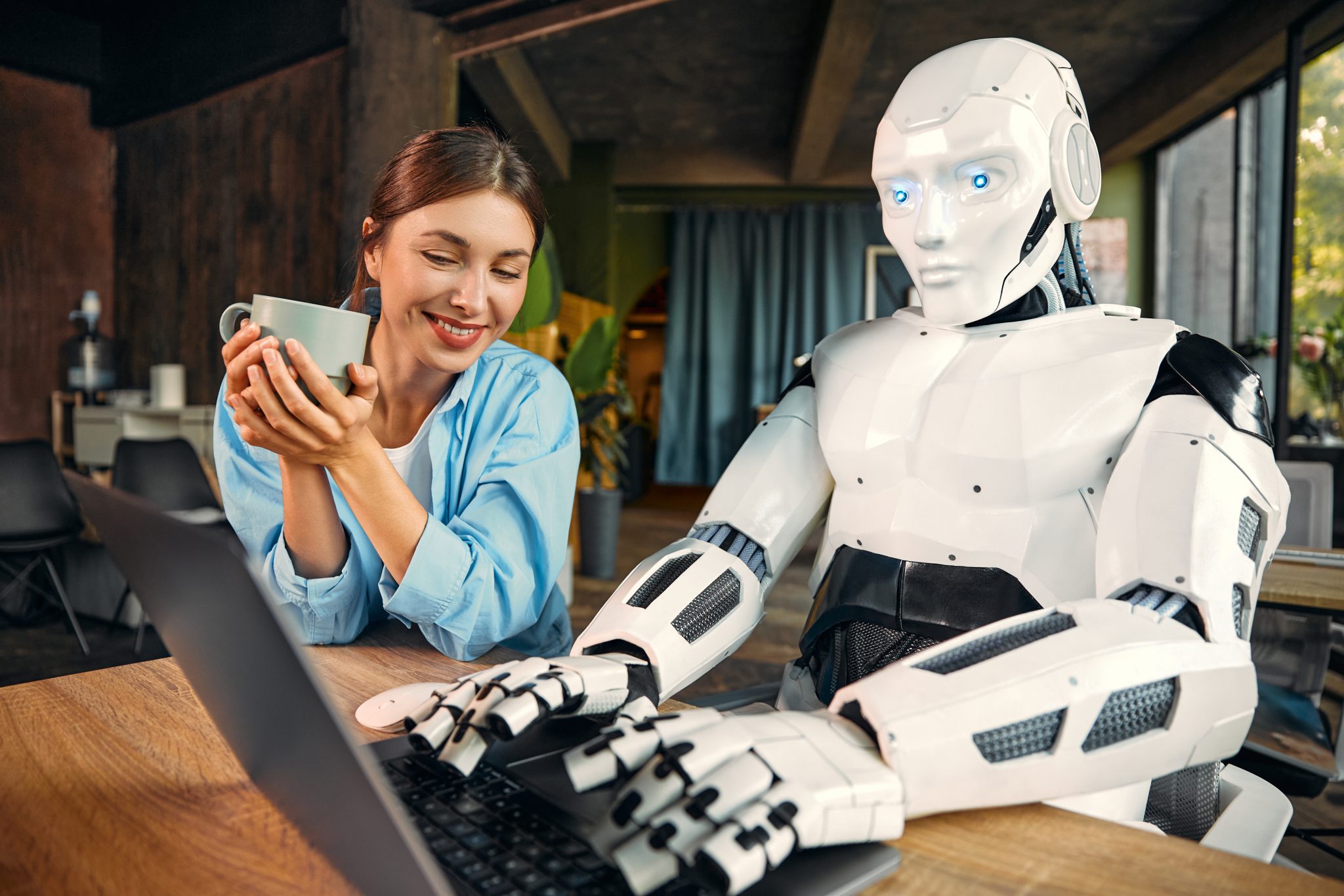 robot and woman working on laptop in office 2023 11 27 04 57 48 utc scaled